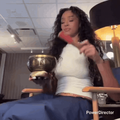 Woman Sitting In Chair Holding Bowl GIF