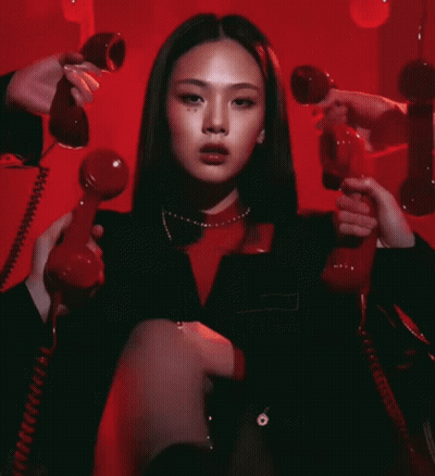 Woman Sitting In Chair Holding Red Telephone GIF