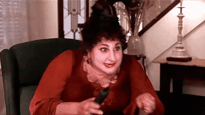 Woman Sitting In Chair Holding Remote GIF