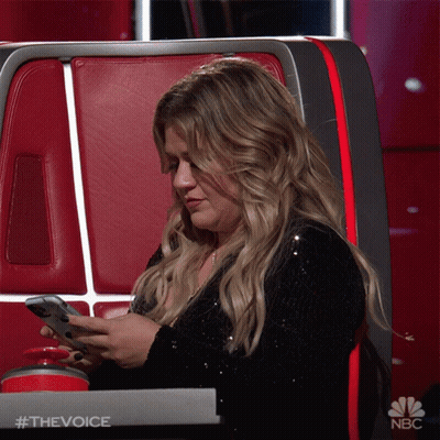 Woman Sitting In Chair Looking At Phone #TheVoice GIF