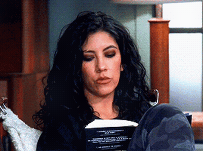 Woman Sitting In Chair Reading Book Legs Crossed GIF