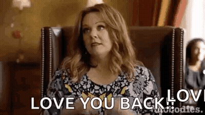 Woman Sitting In Chair Saying Love You Back GIF