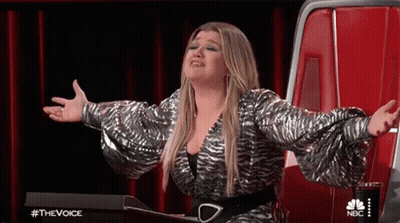 Woman Sitting In Chair With Arms Outstretched On Stage GIF