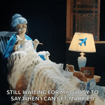 Woman Sitting In Chair With Blanket And Airplane Lamp GIF