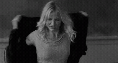 Woman Sitting In Chair With Hair Blowing In Wind GIF