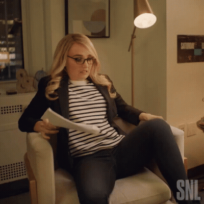 Woman Sitting In Chair With SNL Logo GIF