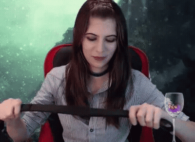 Woman Sitting In Chair With Wine And Belt GIF