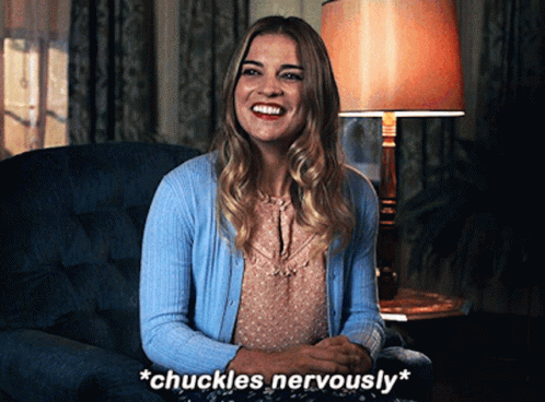 Woman Sitting In Chair With Words Chuckles Nervously GIF