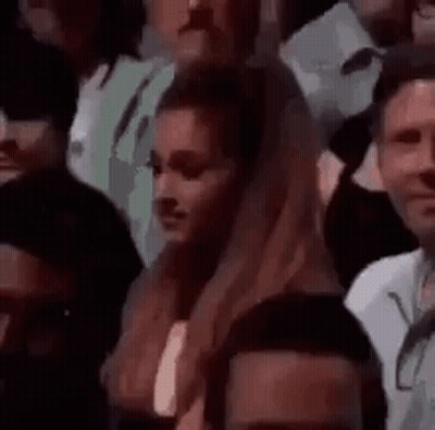 Woman Sitting In Crowd Looking GIF