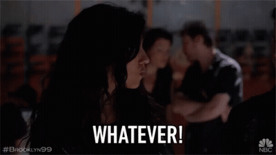 Woman Sitting In Dark Room Saying Whatever GIF