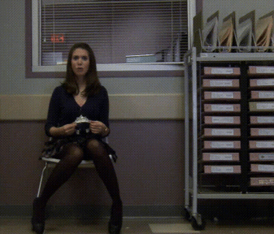 Woman Sitting In Front Of Binder Cart Labeled A GIF