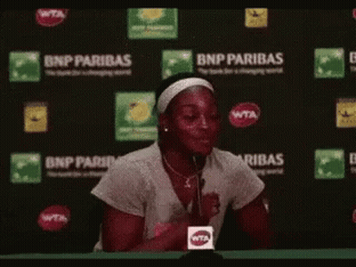 Woman Sitting In Front Of BNP Paribas Sign GIF
