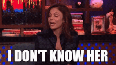 Woman Sitting In Front Of Bookshelf Saying I Don't Know Her GIF