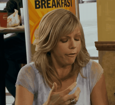 Woman Sitting In Front Of Breakfast Sign GIF