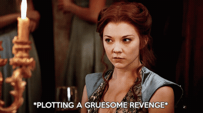 Woman Sitting In Front Of Candle Plotting A Gruesome Revenge GIF