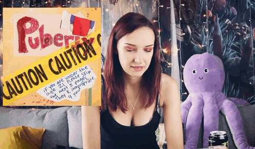 Woman Sitting In Front Of Caution Sign GIF