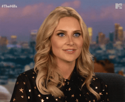 Woman Sitting In Front Of City Skyline GIF