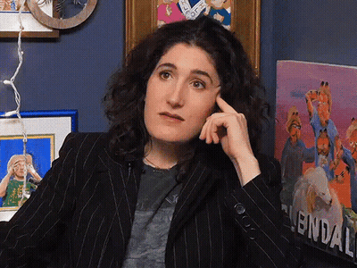 Woman Sitting In Front Of Garfield Painting GIF