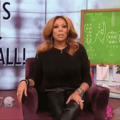 Woman Sitting In Front Of Green Board Saying All GIF