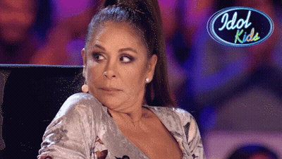 Woman Sitting In Front Of Idol Kids Logo GIF