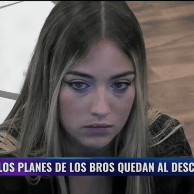 Woman Sitting In Front Of Los Planes De Los Bros Quedan Al Desc Sign GIF