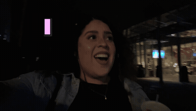 Woman Sitting In Front Of Man Playing Guitar In Dark Room GIF