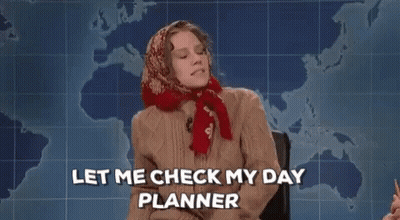 Woman Sitting In Front Of Map Holding Notebook Saying Let Me Check My Day Planner GIF