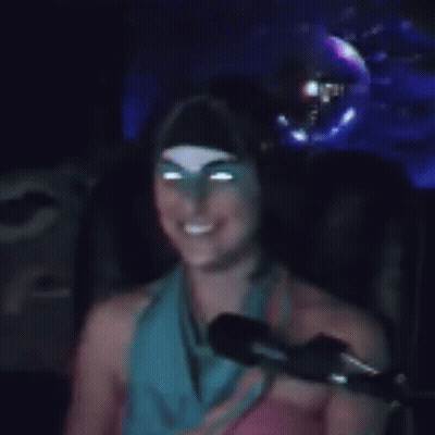 Woman Sitting In Front Of Microphone In Dark Room GIF