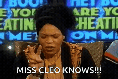 Woman Sitting In Front Of Miss Cleo Knows Sign GIF