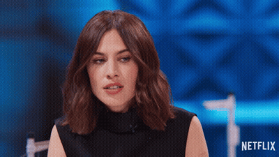 Woman Sitting In Front Of Netflix Sign GIF