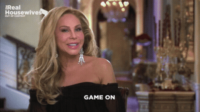 Woman Sitting In Front Of Real Housewives Logo GIF
