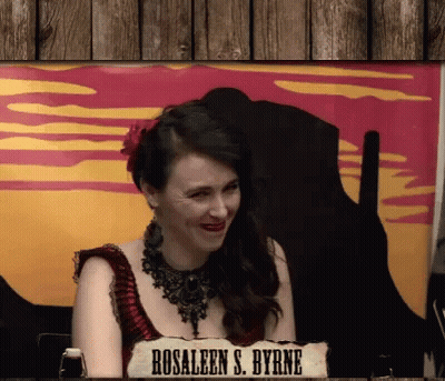Woman Sitting In Front Of Rosaleen S. Byrne Sign GIF