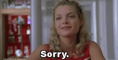 Woman Sitting In Front Of Shelf Saying Sorry GIF
