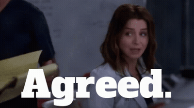 Woman Sitting In Front Of Sign Reading Agreed GIF