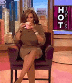 Woman Sitting In Front Of Topics Sign GIF