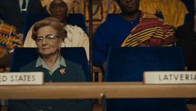 Woman Sitting In Front Of United States Sign GIF