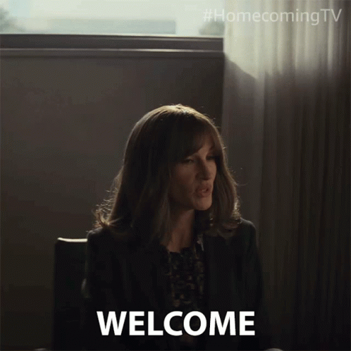 Woman Sitting In Front Of Welcome Sign GIF