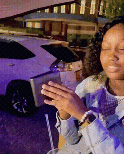 Woman Sitting In Front Of White Car With Straw GIF