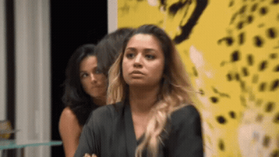 Woman Sitting In Front Of Yellow Leopard Wall GIF