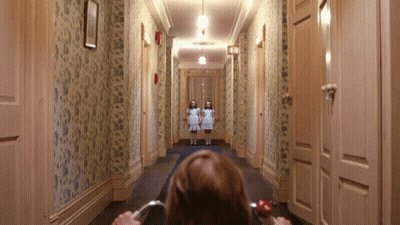 Woman Sitting In Hallway Looking At Two Girls GIF