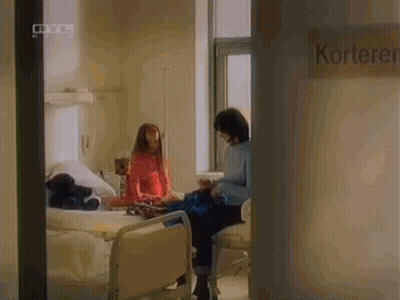 Woman Sitting In Hospital Chair Next To Kortek Sign GIF