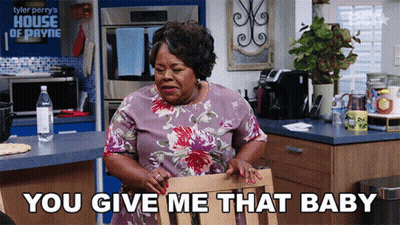 Woman Sitting In Kitchen Saying You Give Me That Baby GIF
