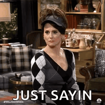 Woman Sitting In Living Room Wearing Hat And Sweater GIF
