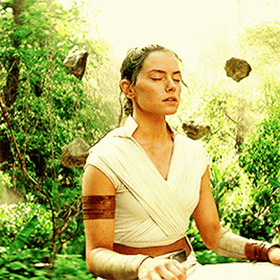 Woman Sitting In Lotus Position With Rocks Flying GIF
