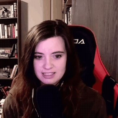 Woman Sitting In Red Chair With A GIF