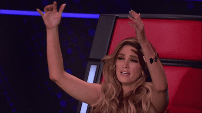 Woman Sitting In Red Chair With Hand On Head GIF