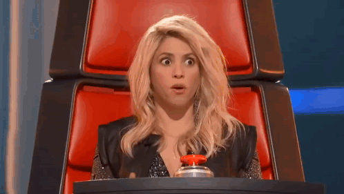 Woman Sitting In Red Chair With Red Button GIF