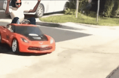 Woman Sitting In Red Toy Car GIF