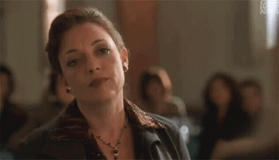 Woman Sitting In Room With Group GIF