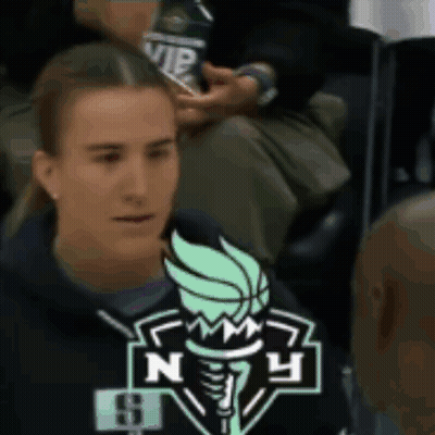 Woman Sitting In Stadium With NY Logo Sweatshirt GIF